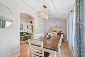 a dining room and living room with a table and chairs at Palm Tree Paradise in Bradenton