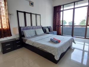 a bedroom with a large bed and a chair at Sea Lion by the beach in George Town