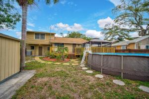 a backyard with a pool and a house at Palm Tree Paradise in Bradenton