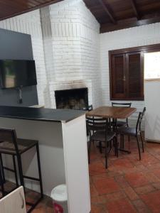 a living room with a table and a fireplace at hotel fazenda ctk in Santa Cruz do Sul