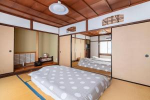 sypialnia z 2 łóżkami w pokoju w obiekcie KIX House Wakeikan 和憩館 w mieście Izumisano