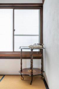 a table in a room with a window at KIX House Wakeikan 和憩館 in Izumi-Sano