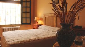 Rúm í herbergi á Hotel Pico Espiguete