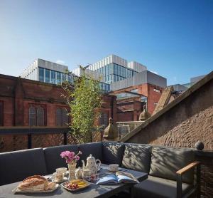 a table with plates of food on top of a balcony at Hammock Heights! Hot Tub,Private Garage,CityCentre in Manchester