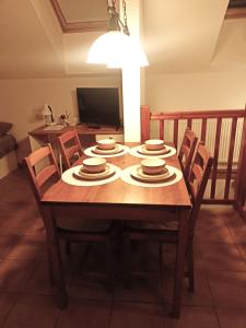 a dining room table with chairs and plates on it at Tourist apartment Vysočina BIKE plus FUN in Nové Město na Moravě