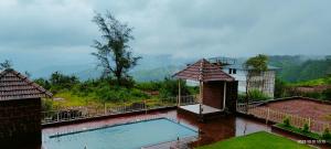 a view of a swimming pool on top of a house at Konark Villa in Mahabaleshwar