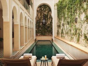 a swimming pool in the middle of a building at IZZA Marrakech in Marrakesh