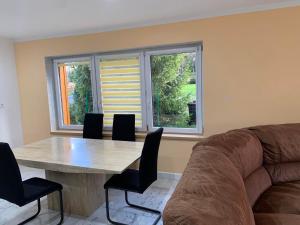 a living room with a table and a couch at Dom w górach z bilardem in Juszczyna