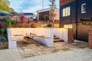a patio with a table and a fence at Coppergate Mews Apartment 4 in Doncaster