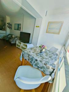 a living room with a table and a chair at Agata Beach in Benalmádena