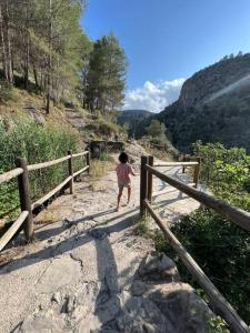 a young child walking on a path in the mountains at Apto. Rural Cielo. Al lado Torre in Jérica