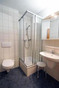 a bathroom with a shower and a toilet and a sink at Yachthafenresidenz-Wohnung-8304-860 in Kühlungsborn