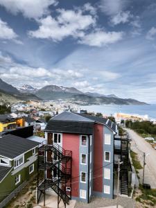 a view of a city with houses and the water at Robinson Alojamientos - Edificio Erico Orlando in Ushuaia