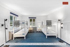 a room with three bunk beds in it at Budget Living in the outskirts of Zurich in Dietikon