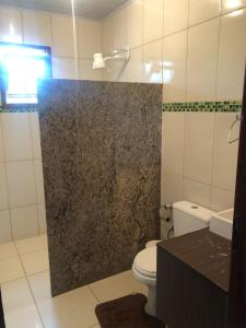 een badkamer met een douche, een toilet en een wastafel bij Rancho Nova Esperança 