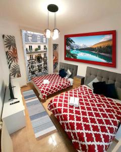 a bedroom with a red and white bed and a window at SOL Montera & PARKING TPH in Madrid