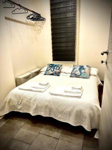 - une chambre avec un lit et des serviettes dans l'établissement LAVIKA - Luxury Holiday Home, à Aci Trezza