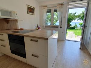 a kitchen with a sink and a counter top at Apartment with SeaView and Garden for 6 in Portorož