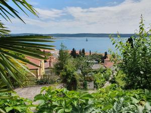 a view of a large body of water with a sail boat at Apartment with SeaView and Garden for 6 in Portorož