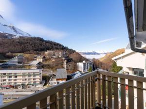 a view from a balcony of a town with a mountain at Appartement 4 pers cosy avec wifi et casier à skis, Vue pistes, Gourette - FR-1-400-123 in Eaux-Bonnes
