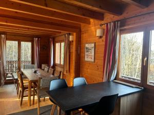 a dining room with a table and chairs at Chalet de charme aux Carroz d'Arrâches-Flaines in Les Carroz d'Araches