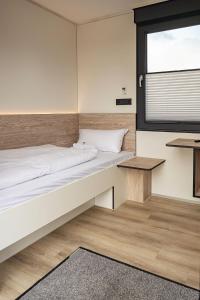 a bedroom with a large bed and a window at Roatel Magdeburg A2 my-roatel-com in Magdeburg