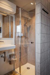a shower with a glass door in a bathroom at Roatel Magdeburg A2 my-roatel-com in Magdeburg