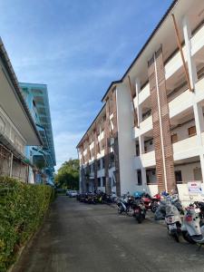 a row of motorcycles parked in front of a building at Chalong Interview Condominium - Chalong in Chalong 