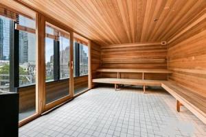 a sauna with a bench in a room with windows at Stunning 2BR Apt nr Yarra City view Free parking in Melbourne