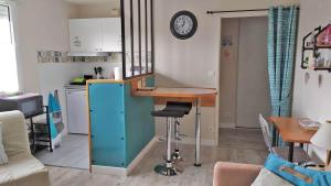 a kitchen with a desk and a table in a room at a lovely nest in Bussy-Saint-Georges