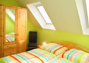 twee bedden in een slaapkamer met groene muren bij Ferienwohnung Biber im Müritz Seepark in Marienfelde