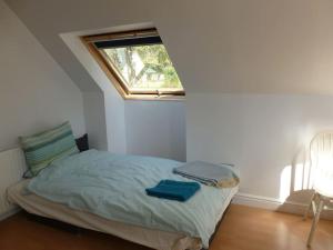 a small bedroom with a bed with a window at The Bothy, Nethy Bridge in Nethy Bridge