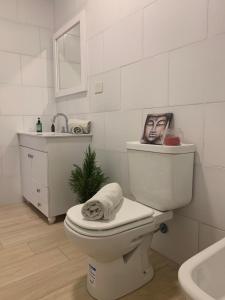 La salle de bains est pourvue de toilettes avec une photo d'un homme. dans l'établissement Altos de la Cañada, à Mariano Moreno