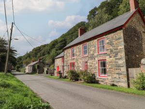 a stone house on the side of a road at Sycamore Vestry in Fishguard