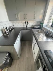 a kitchen with a sink and a counter top at Lovely 1 bedroom flat. Parking & Garage. Sky TV & Broadband in Colchester
