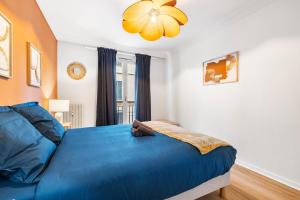 um quarto com uma cama azul e uma janela em NICE RENTING - PHILIBERT - Elegant Spacious Quiet Near the Port Free Parking em Nice