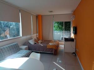 Habitación pequeña con cama y sofá en ABASTO EL SOLAR PREMIUM en Buenos Aires