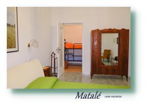 a living room with a couch and a mirror at Matalé - casa vacanze in Taranto +59 photos