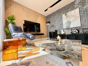 a living room with a couch and a glass table at C Living - Executive - AQIQ in Riyadh +136 photos