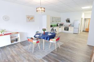 a kitchen and dining room with a table and chairs at Fewo Am Rathaus - ABC351 in Wismar +12 photos