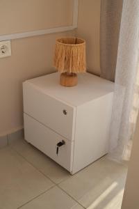 a white dresser with a lamp on top of it at LARA BOUTIQUE HOTEL Antalya in Lara