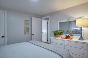 a bedroom with a bed and a dresser with a mirror at South Dennis Vacation Rental about 5 Mi to Beach! in South Dennis