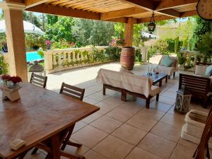 a patio with tables and chairs under a pavilion at Maison de vacances dans le verdon in Saint-Julien