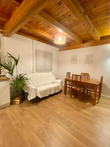 a bedroom with a bed and a table and chairs at La espiga de Segovia 2 in La Lastrilla