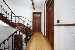 a hallway with a staircase and a wooden door at numa I Luna Apartments in Madrid