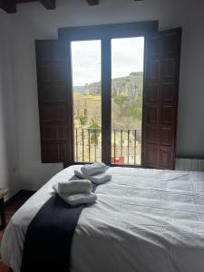 a bedroom with a large bed with towels on it at Rascacielos San Martín in Cuenca