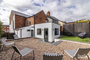 a house with a courtyard with chairs in the yard at Carlton Hill House - 5 Bedroom House with Parking in Nottingham