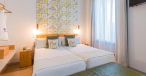 Posteľ alebo postele v izbe v ubytovaní Hotel Catalina