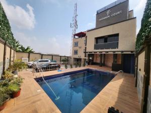 a swimming pool in front of a building at Frennin Court in Accra