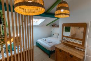 a small bedroom with a bed and a mirror at SURF HOSTEL BIARRITZ in Biarritz